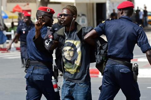 Police officers detain a demonstrator during a protest calling for an investigation after the BBC's corruption report over Senegal's oil wells involving Aliou Sall, brother of Senegal's President Macky Sall in Dakar, Senegal, June 14, 2019, PHOTO BY REUTERS/Sylvain Cherkaoui