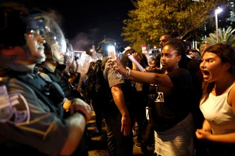 Protesters stand opposite police during a protest for the death of 18-year old Solomon Tekah of Ethiopian descent, after he was shot by police, in Tel Aviv, Israel July 2, 2019. PHOTO BY REUTERS/ Corinna Kern