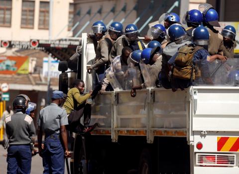 Riot police detain suspected opposition Movement for Democratic Change (MDC) supporters during clashes after police banned planned protests over austerity and rising living costs called by the opposition Movement for Democratic Change (MDC) party in Harare, Zimbabwe, August 16, 2019. PHOTO BY REUTERS/Philimon Bulawayo