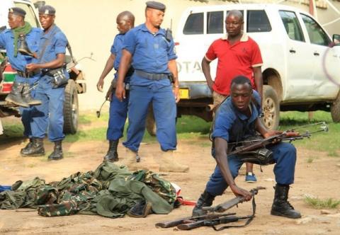 Burundian police officers collect a cache of weapons recovered from suspected fighters after clashes in the capital Bujumbura, Burundi, December 12, 2015. PHOTO BY REUTERS/Jean Pierre Aime Harerimana