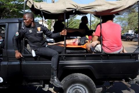 Security forces evacuate an injured person in Bassam, Ivory Coast, March 13, 2016. PHOTO BY REUTERS/Joe Penney