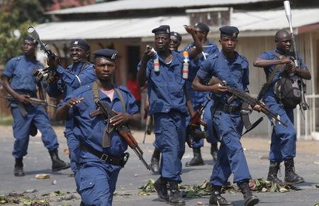 Policemen prepare to throw tear gas canisters during a protest against President Pierre Nkurunziza's decision to run for a third term in Bujumbura, Burundi, May 29, 2015. PHOTO BY REUTERS/Goran Tomasevic