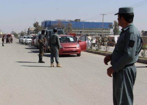 Afghan policemen inspect vehicles at a checkpoint in Helmand province, Afghanistan, February 28, 2017. PHOTO BY REUTERS/Abdul Malik