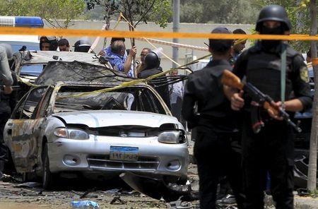 Policemen secure the site of a car bomb attack on the convoy of Egyptian public prosecutor Hisham Barakat near his house at Heliopolis district in Cairo, June 29, 2015. PHOTO BY REUTERS/Mohamed Abd El Ghany