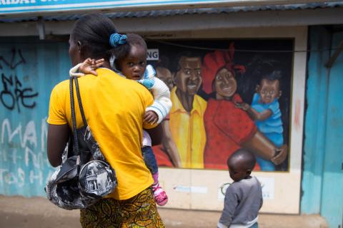 A woman walks past a murel during a visit by Netherlands Minister for Trade and Development Cooperation Lilianne Ploumen at a Family Health Options clinic in the Kibera slums in Nairobi, Kenya, May 16, 2017. PHOTO BY REUTERS/Baz Ratner