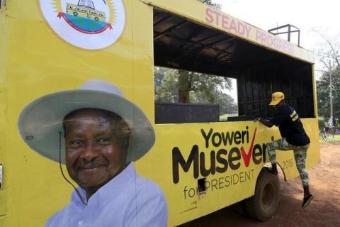 A woman gets off a truck with pictures of National Resistance Movement (NRM) party candidate Yoweri Museveni in Masindi town January 23, 2016 ahead of the February 18 presidential election. PHOTO BY REUTERS/James Akena