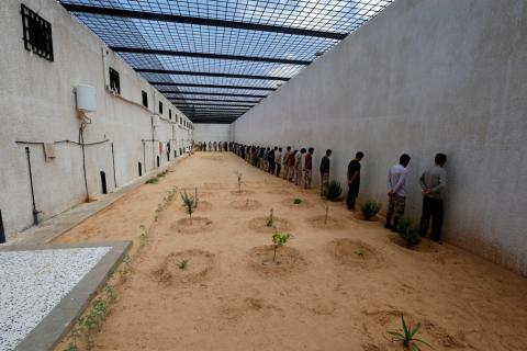 Troops from eastern Libyan forces stand against a wall, after being captured by forces loyal to the Libyan internationally recognized government in Ain Zara, south of Tripoli, Libya, April 11, 2019. PHOTO BY REUTERS/Ismail Zitouny