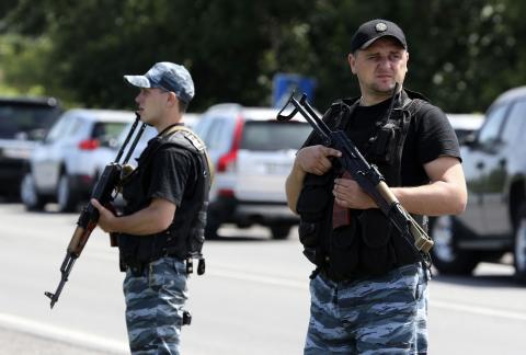 Armed pro-Russian separatists stand guard on the suburbs of Shakhtarsk, Donetsk region