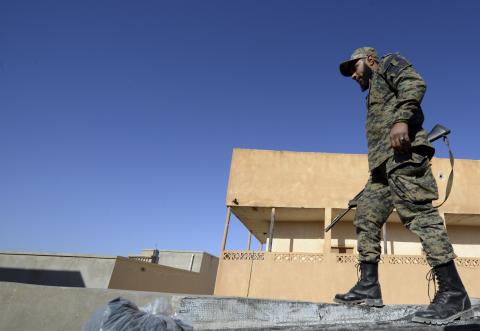 A member of Libyan pro-government forces, who are backed by the locals, holds a weapon during clashes with the Shura Council of Libyan Revolutionaries in the streets of Benghazi, January 19, 2015. PHOTO BY REUTERS/Esam Omran Al-Fetori