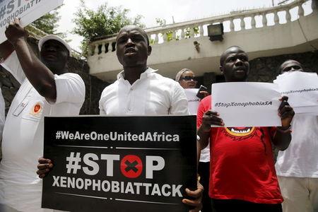 People protesting against xenophobia in South Africa hold placards in front of the South African consulate in Lagos, April 16, 2015. PHOTO BY REUTERS/Akintunde Akinleye