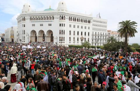 People carry national flags and banners during a protest calling on President Abdelaziz Bouteflika to quit, in Algiers, Algeria, March 19, 2019. PHOTO BY REUTERS/Ramzi Boudina