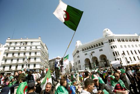 People carry national flags during a protest to demand the removal of President Abdelaziz Bouteflika in Algiers, Algeria, March 29, 2019. PHOTO BY REUTERS/Ramzi Boudina