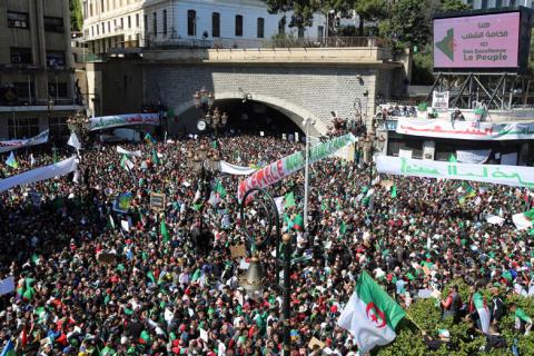 People carry national flags and banners during a protest to demand the resignation of President Abdelaziz Bouteflika, in Algiers, Algeria, March 29, 2019. PHOTO BY REUTERS/Ramzi Boudina