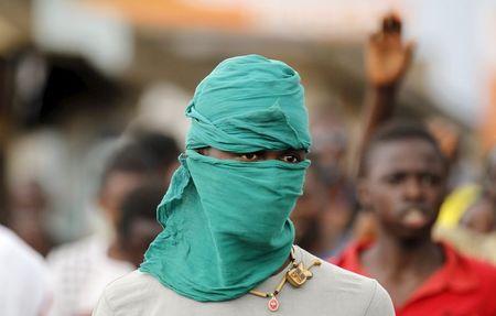 A protester is seen with his face covered during demonstrations against the ruling CNDD-FDD party's decision to allow President Pierre Nkurunziza to run for a third five-year term in office, in Bujumbura, Burundi, April 29, 2015. PHOTO BY REUTERS/Thomas Mukoya