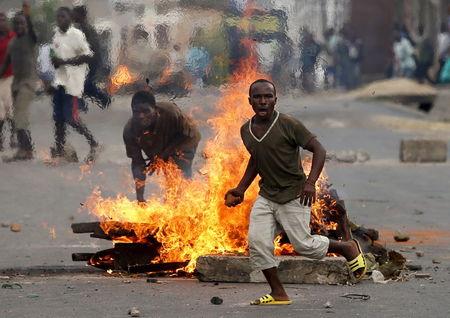 A protester runs in front of a burning barricade during a protest against Burundi President Pierre Nkurunziza and his bid for a third term in Bujumbura, Burundi, May 21, 2015. PHOTO BY REUTERS/Goran Tomasevic