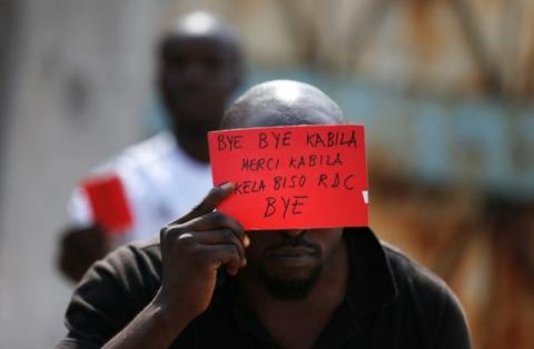 A Congolese opposition party supporter displays a red card against President Joseph Kabila in Kinshasa, Democratic Republic of Congo, December 19, 2016. PHOTO BY REUTERS/Thomas Mukoya