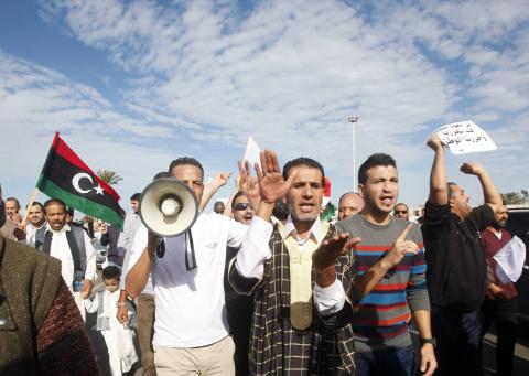 Protesters march during a demonstration calling on militiamen to leave, in Tripoli