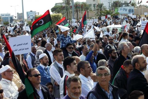 Protesters march during a demonstration calling on militiamen to leave, in Tripoli