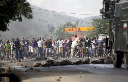 Protesters throw stones to a water cannon during clashes with riot police against the decision made by Burundi's ruling National Council for the Defence of Democracy (CNDD-FDD) party to allow President Pierre Nkurunziza to run for a third five-year term in office, in the capital Bujumbura, April 27, 2015. PHOTO BY REUTERS/Thomas Mukoya