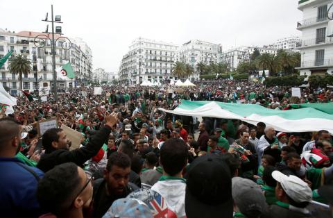 Demonstrators hold flags and banners demanding the departure of Algeria's ruling elite, a month after the downfall of President Abdelaziz Bouteflik, during an anti-government protest in Algiers, Algeria, May 3, 2019. PHOTO BY REUTERS/Ramzi Boudina