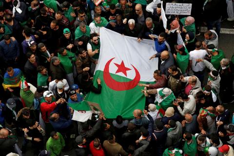 Demonstrators hold flags and banners as they return to the streets to press demands for wholesale democratic change well beyond former president Abdelaziz Bouteflika's resignation in Algiers, Algeria, April 19, 2019. PHOTO BY REUTERS/Ramzi Boudina