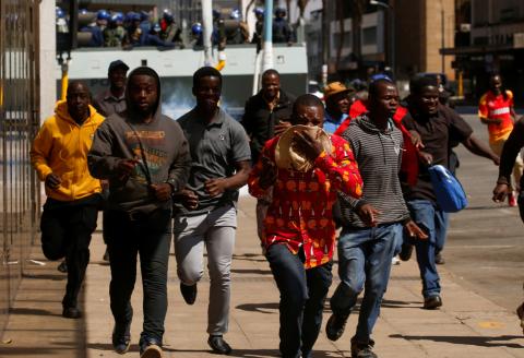 Protesters flee from teargas during clashes after police banned planned protests over austerity and rising living costs called by the opposition Movement for Democratic Change (MDC) party in Harare, Zimbabwe, August 16, 2019. PHOTO BY REUTERS/Philimon Bulawayo