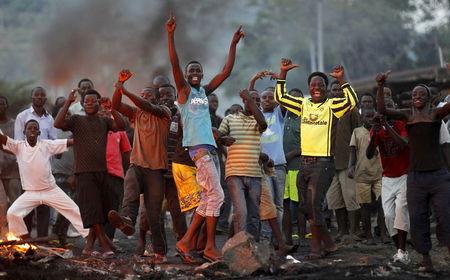 Protestors chant anti-government slogans as they clash with riot police during a protest against Burundi's ruling party's decision to allow President Pierre Nkurunziza to run for a third five-year term in office, in the capital Bujumbura, April 27, 2015. PHOTO BY REUTERS/Thomas Mukoya