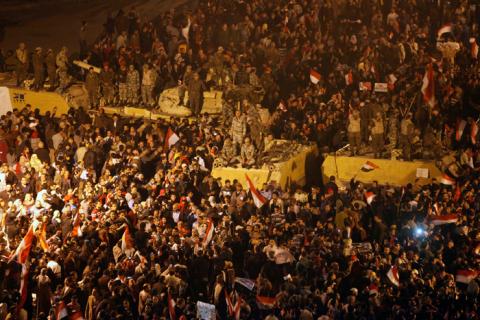 Anti-government protesters celebrate next to soldiers inside Tahrir Square after the announcement of Egyptian President Hosni Mubarak's resignation in Cairo February 11, 2011. REUTERS/Asmaa Waguih/