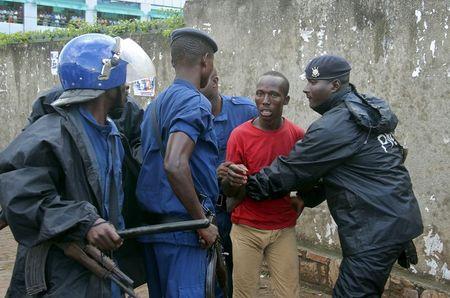 Burundi policemen detain a protestor who opposes President Pierre Nkurunziza from running for a third term, in the capital Bujumbura, April 17, 2015. PHOTO BY REUTERS/Jean Pierre Aime Harerimana