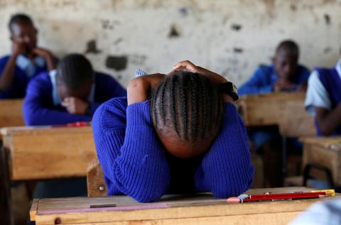 A pupil prays inside a classroom ahead of the primary school final national examinations at a primary school in Nairobi, Kenya, October 31, 2017. PHOTO BY REUTERS/Thomas Mukoya