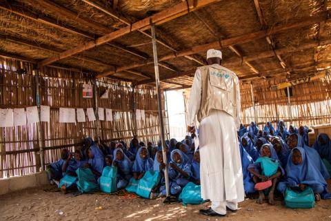 UNICEF education specialist Yusef Ismail talks to pupils at a class at a primary school in Muna Garage IDP camp, Maiduguri, Nigeria, November 7, 2016. PHOTO BY REUTERS/UNICEF