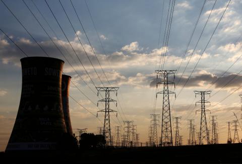 Electricity pylons are seen along the cooling tower of the defunct Orlando Power Station in Soweto, South Africa, June 28, 2018. PHOTO BY REUTERS/Siphiwe Sibeko