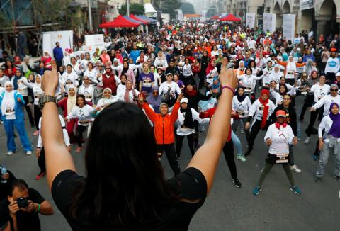 Women raise their arms before starting the first Egyptian womens' race, to raise awareness about violence against women, in the neighbourhood of Heliopolis, Cairo, Egypt, November 30, 2018. PHOTO BY REUTERS/Amr Abdallah Dalsh