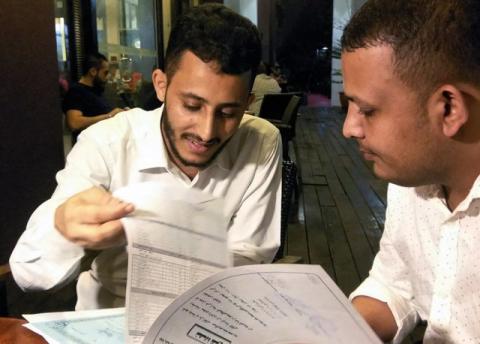 Yemeni Rafek Ahmed Mohammed Al-Sanani (R), 22, and Abdel Rahman Zaid, 26 look through documents as they speak with Reuters in Serdang, on the outskirts of Kuala Lumpur, Malaysia, July 20, 2017. PHOTO BY REUTERS/Rozanna Latiff