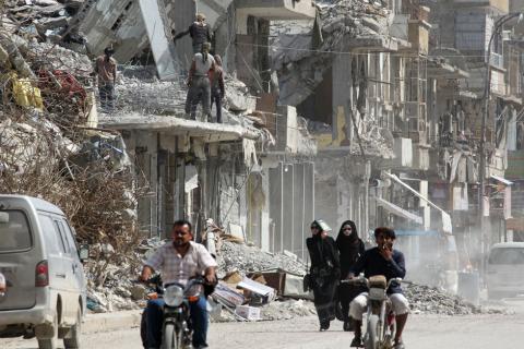 Women walk past rubble of damaged buildings in Raqqa, Syria May 14, 2018. PHOTO BY REUTERS/Aboud Hamam