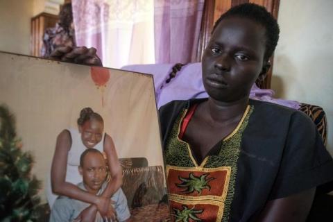 South Sudanese Rebecca Chuol Ungdeng with a portrait of her and her late husband John Gatluak, a South Sudanese aid worker who was killed by government soldiers during the attack on the Terrain hotel compound in Juba, South Sudan on July 11, 2016. PHOTO BY REUTERS/Stringer