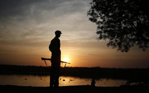 A rebel fighter stands on the bank of Sobat river at a village in a rebel-controlled territory in Upper Nile State