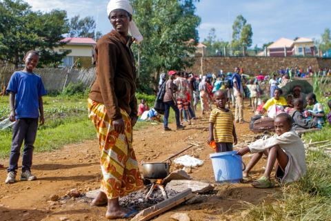 A refugee from the Democratic Republic of Congo is seen with her children as they prepare a meal near the United Nations High Commissioner for Refugees (UNHCR) offices in Kiziba refugee camp in Karongi District, Rwanda, February 21, 2018. PHOTO BY REUTERS/Jean Bizimana
