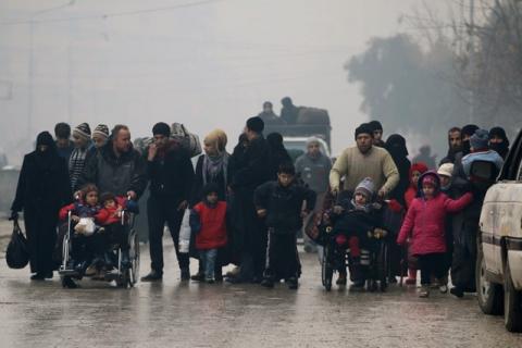 People walk as they flee deeper into the remaining rebel-held areas of Aleppo, Syria, December 13, 2016. PHOTO BY REUTERS/Abdalrhman Ismail