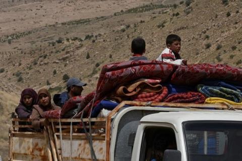 Syrian Refugees seen on the back of a truck at Lebanon's border region of Arsal, Lebanon, July 12, 2017. PHOTO BY REUTERS/Hassan Abdallah