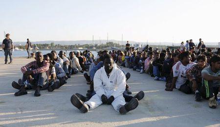 Migrants rest after disembarking in the Sicilian harbour of Augusta, Italy, June 23, 2015. PHOTO BY REUTERS/Antonio Parrinello