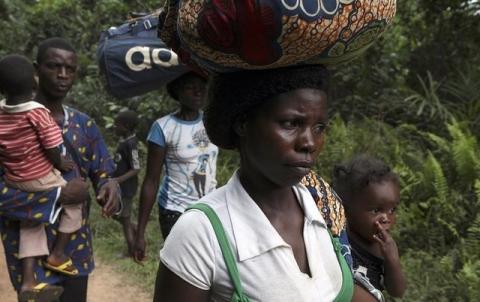 Refugees from Ivory Coast walk with their their belongings through Grand Gedeh county in eastern Liberia, March 23, 2011. PHOTO BY REUTERS/Simon Akam