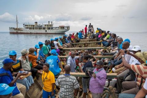 Refugees from Burundi who fled the ongoing violence and political tension and aid workers sail on a boat to reach MV Liemba, a ship freighted by the United Nations at the Kagunga landing base on the shores of Lake Tanganyika near Kigoma in Tanzania, in this May 26, 2015 handout photo by PLAN INTERNATIONAL. PHOTO BY REUTERS