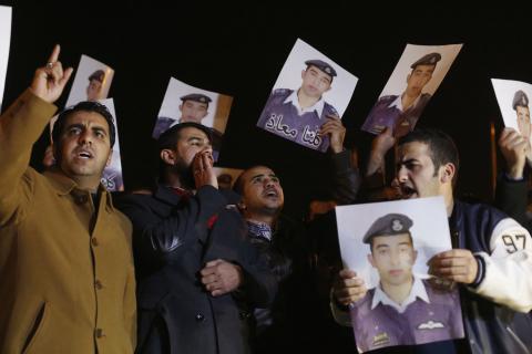 Relatives of Islamic State captive Jordanian pilot Muath al-Kasaesbeh hold up his pictures as they chant slogans demanding that the Jordanian government negotiate with Islamic state and for the release of Kasaesbeh, in front of the prime minister's building in Amman, January 27, 2015. PHOTO BY REUTERS/Muhammad Hamed