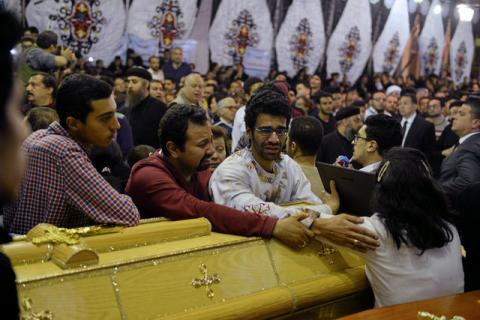 Relatives of victims react next to coffins arriving to the Coptic church that was bombed on Sunday in Tanta, Egypt, April 9, 2017. PHOTO BY REUTERS/Mohamed Abd El Ghany