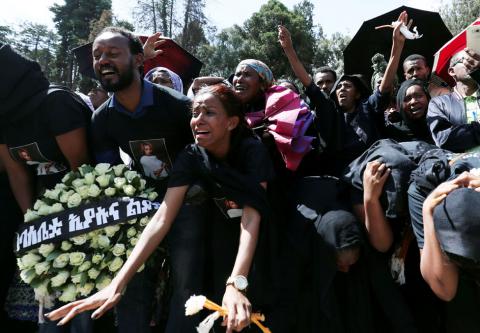 Relatives mourn next to the coffins of Ethiopian passengers and crew members, during a memorial service for the victims of the Ethiopian Airlines Flight ET 302 plane crash, at the Holy Trinity Cathedral Orthodox church in Addis Ababa, Ethiopia, March 17, 2019. PHOTO BY REUTERS/Tiksa Negeri