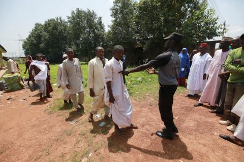 Relatives wait on the sidelines as officials organise some of the people freed by police in Kaduna, Nigeria, September 28, 2019. PHOTO BY REUTERS/Afolabi Sotunde