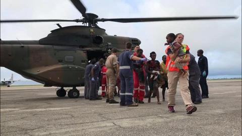 Rescue workers help affected people disembark from a helicopter after cyclone damage in Beira, Mozambique March 19, 2019 in this image taken from social media. Picture taken March 19, 2019. PHOTO BY REUTERS/IPSS Medical Rescue