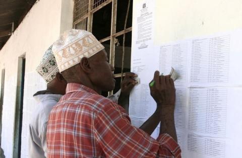 Residents check their names at the electorate list released by the National Electrol Commission of Tanzania (NEC) in Dar es Salaam, in a file photo. PHOTO BY REUTERS/Emmanuel Kwitema