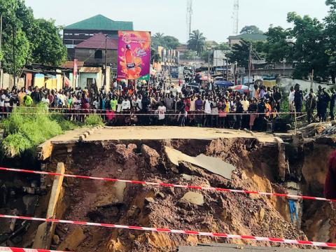 Residents stand near the scene of a landslide following torrential rains near the University of Kinshasa, in the Democratic Republic of Congo, November 26, 2019. PHOTO BY REUTERS/Kenny Katombe